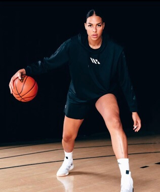 Liz Cambage is posing with a basketball.